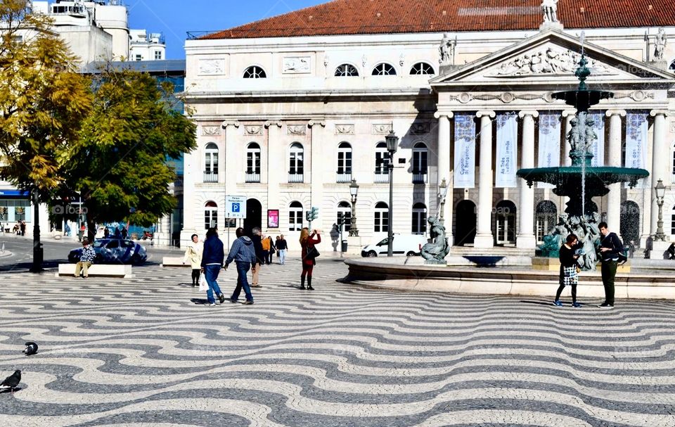 Unique Portuguese pavement tiles in Lisbon’s Rossio Square, Portugal creating a mosaic-style optical illusion of bumps or waves. 