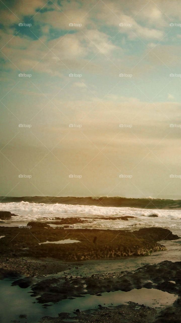 enjoying sunlight with the view of the beach of Kuta, in Bali, Indonesia ...