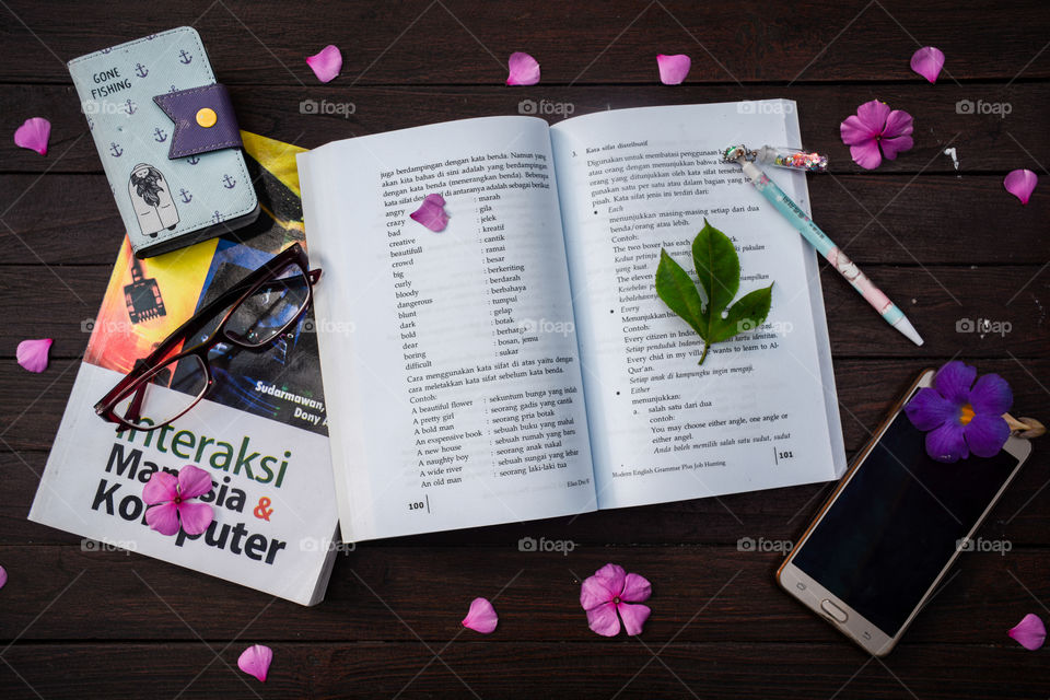 book on the wooden table with flower