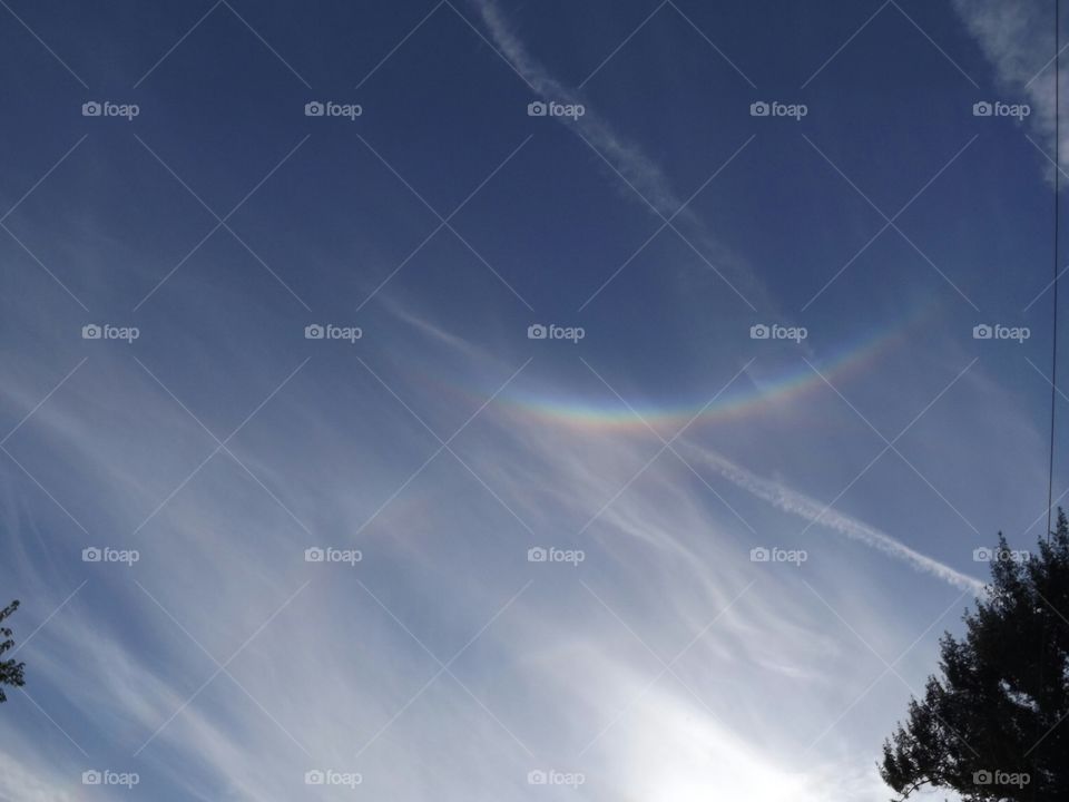 Praying Hands and Arms reaching through the rainbow