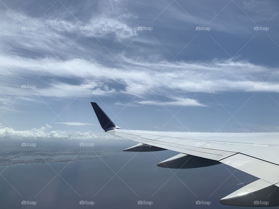 Airplane wing, blue sky, white clouds, weather, sunny day, traveling, flying, space. 