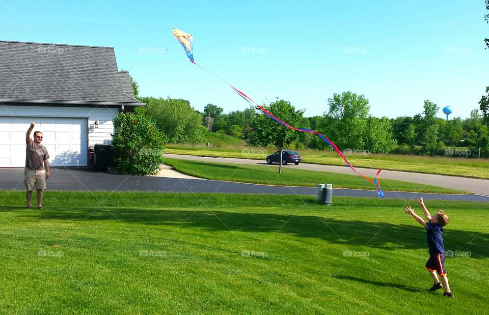 go fly a kite. my son and husband flying a kite together
