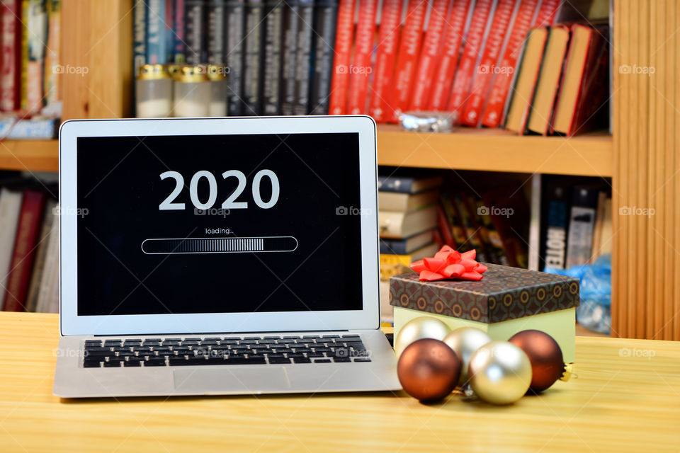Text - 2020 loading and loading bar on laptop desktop, bookshelf, christmas ball, new year concept