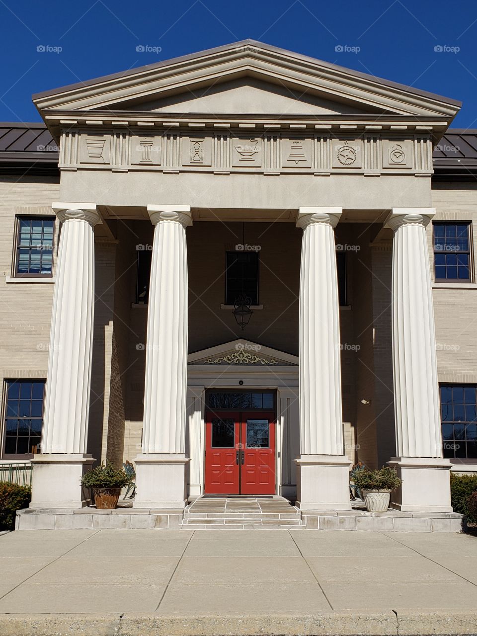 Grand entrance with columns and red double door
