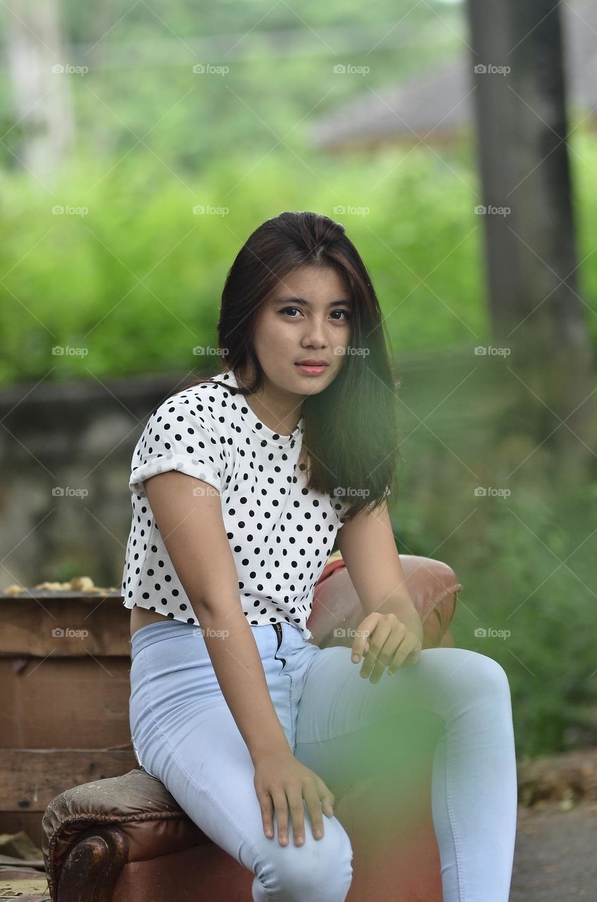 a beautiful girl is posing in casual clothes