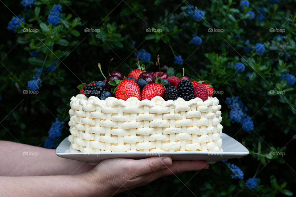Intertwined cream summer berries cake.
