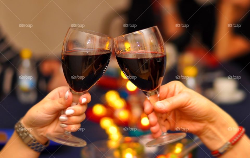 Two people hands toasting wine