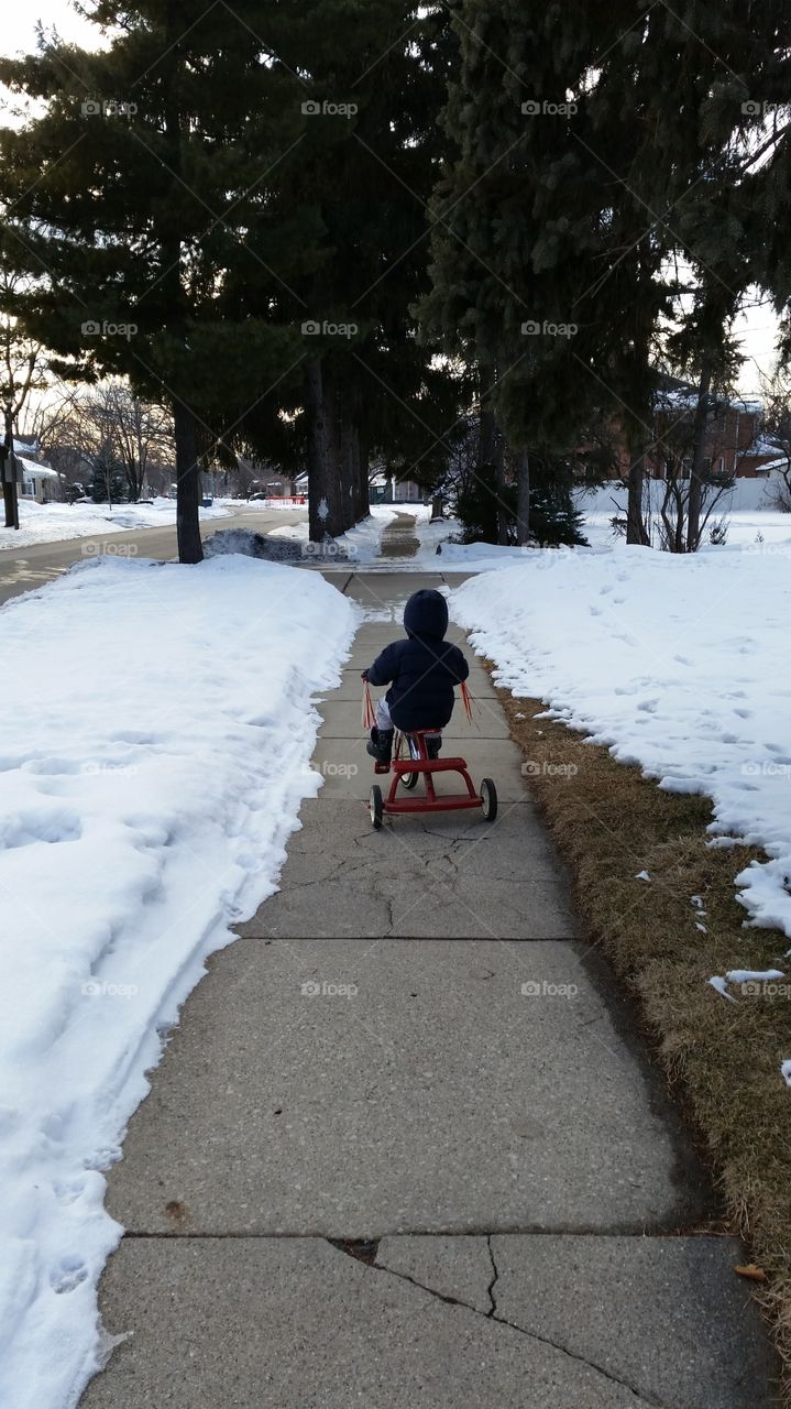lonely trike ride . My son wanted to rode his trike. It was freezing.  