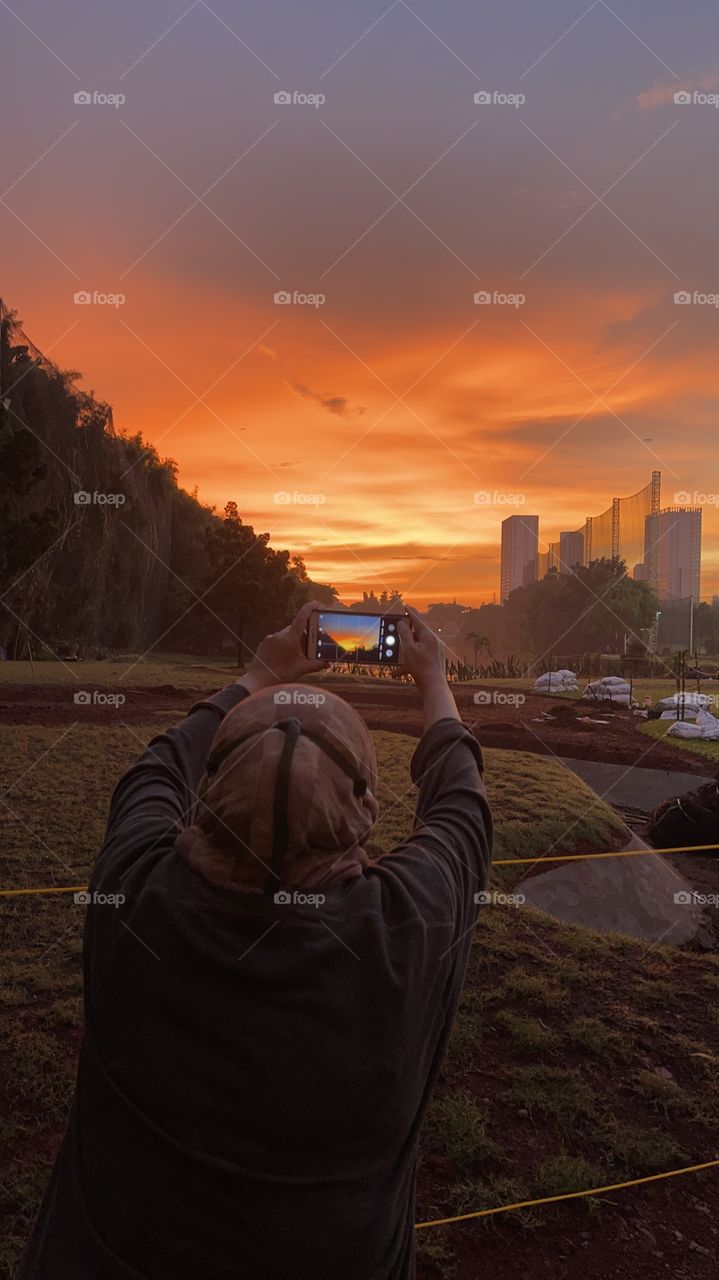 Sunset shooter with smartphone,at golf land while the twilight are beautiful