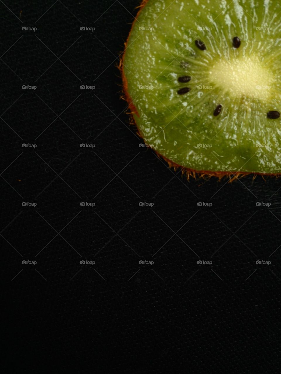 Part of kiwi fruit isolated on black 