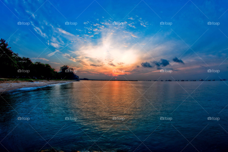 beach singapore orange sunrise by paulcowell