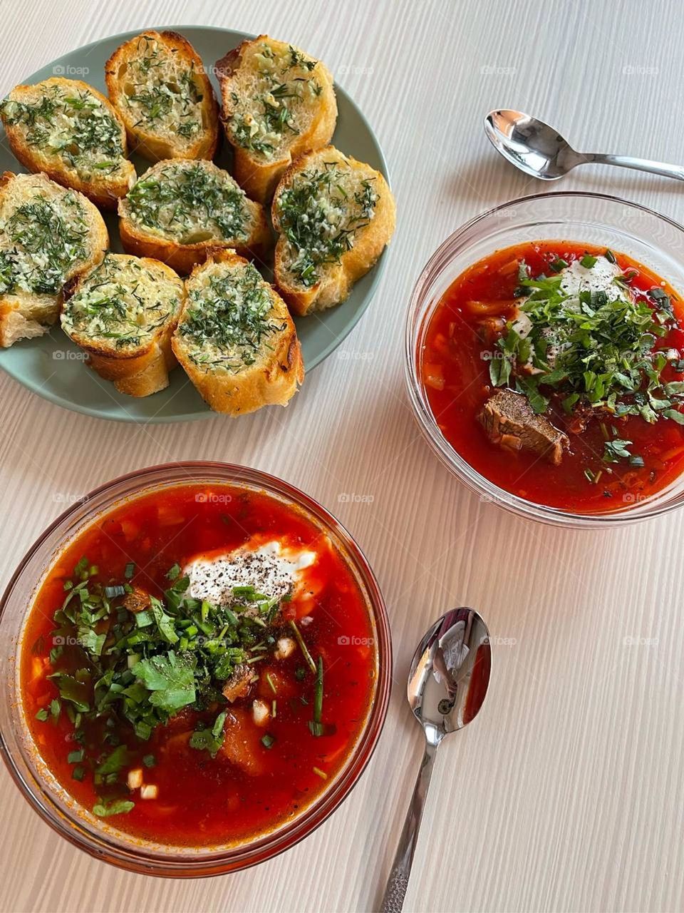 Ukrainian dish red borscht with homemade pastries, namely donuts with garlic