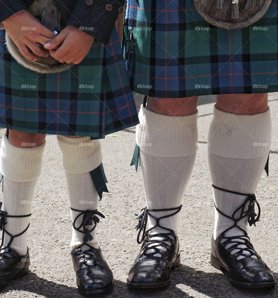 Capturing a moment at a Scottish Wedding ... father and son guests arrive wearing traditional Scottish clan kilts ...