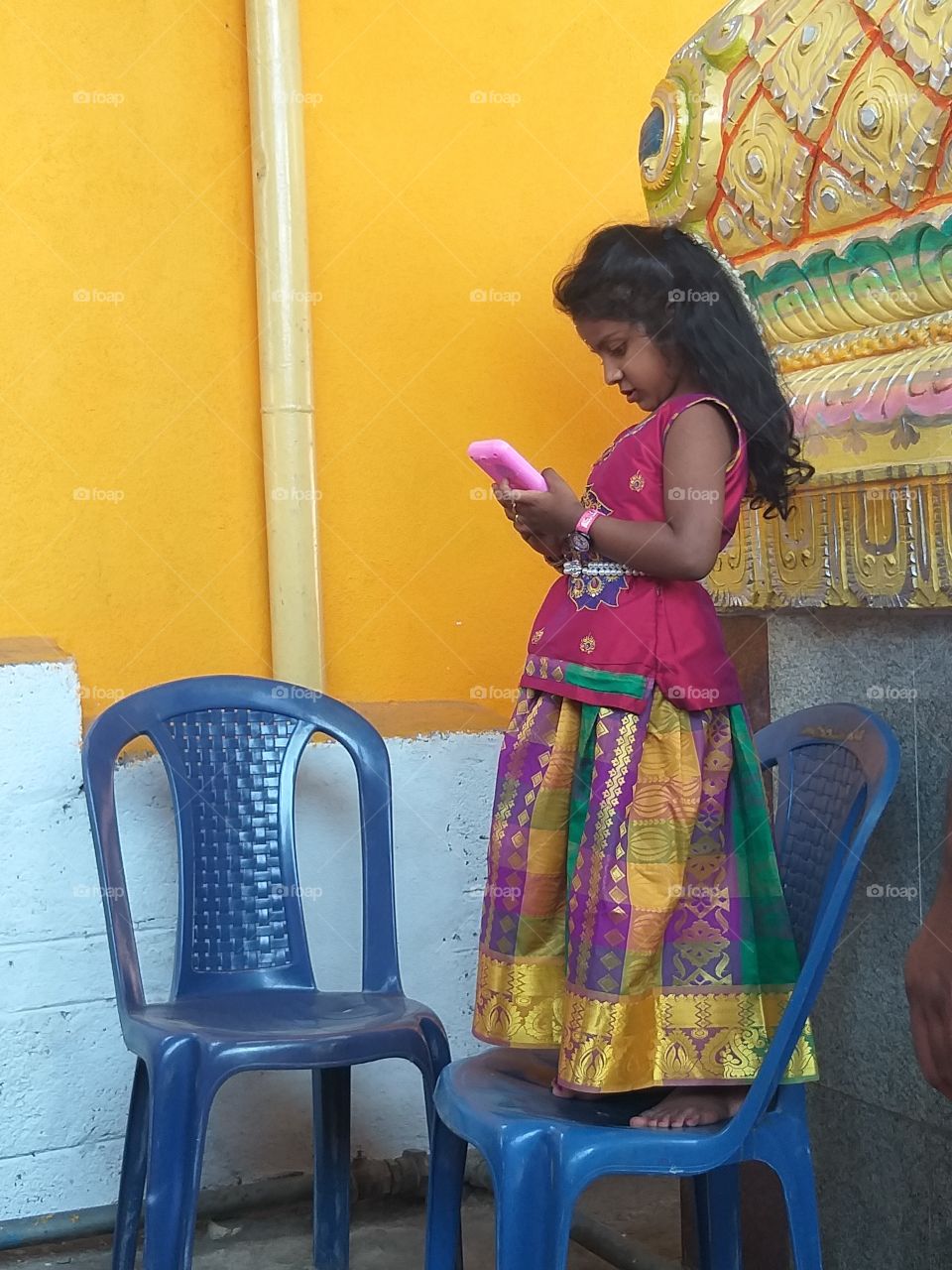 child playing with cellphone.