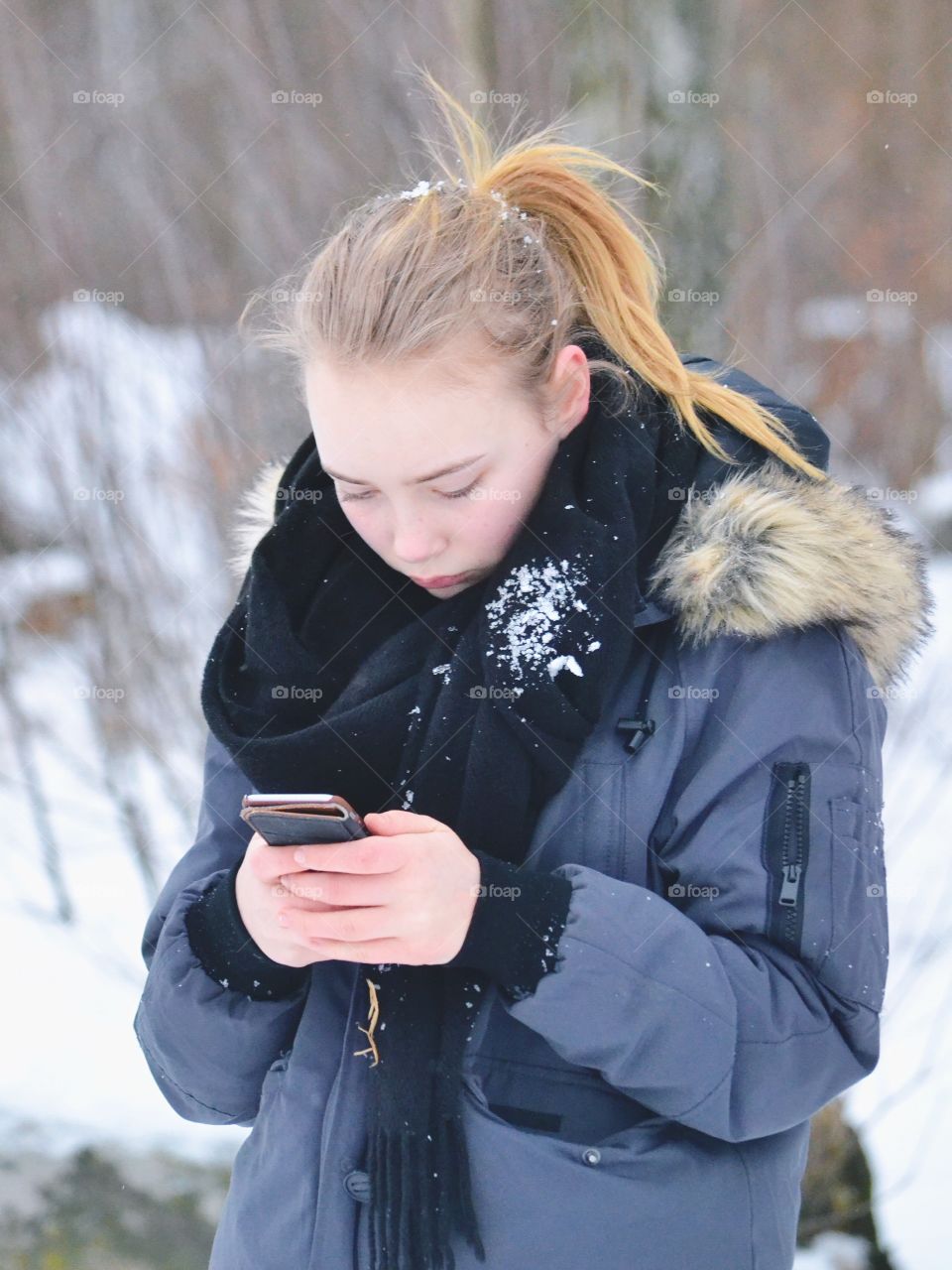 Girl using her phone outdoors