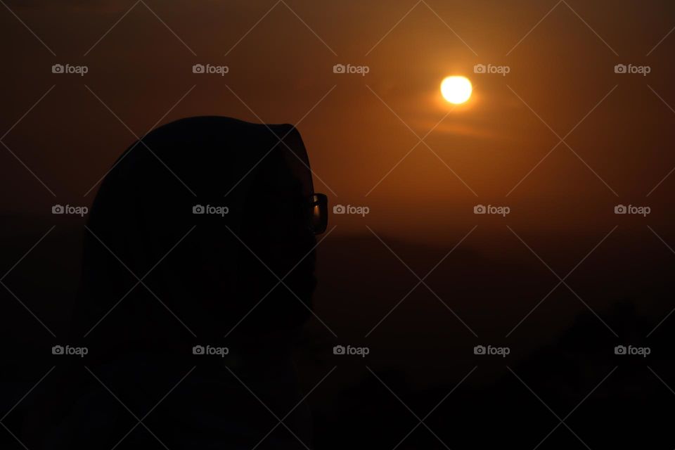 Silhouette of a girl with beautiful sunrise background 