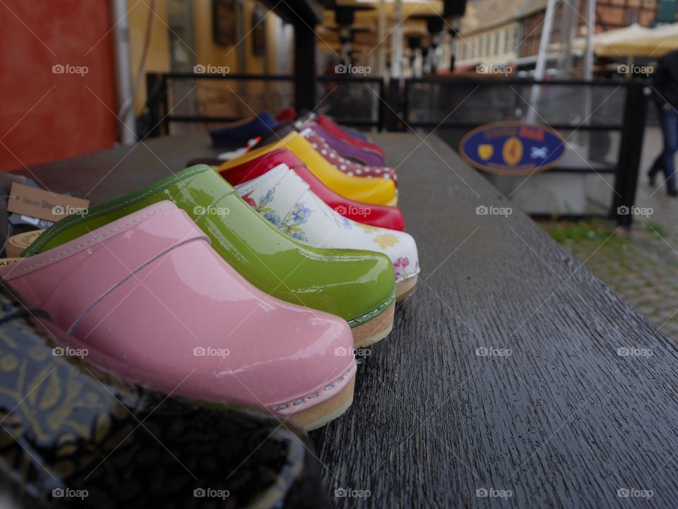 Different colored clogs on a market