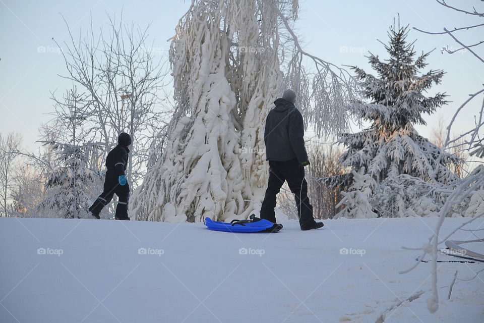 Man holding sled in winter time