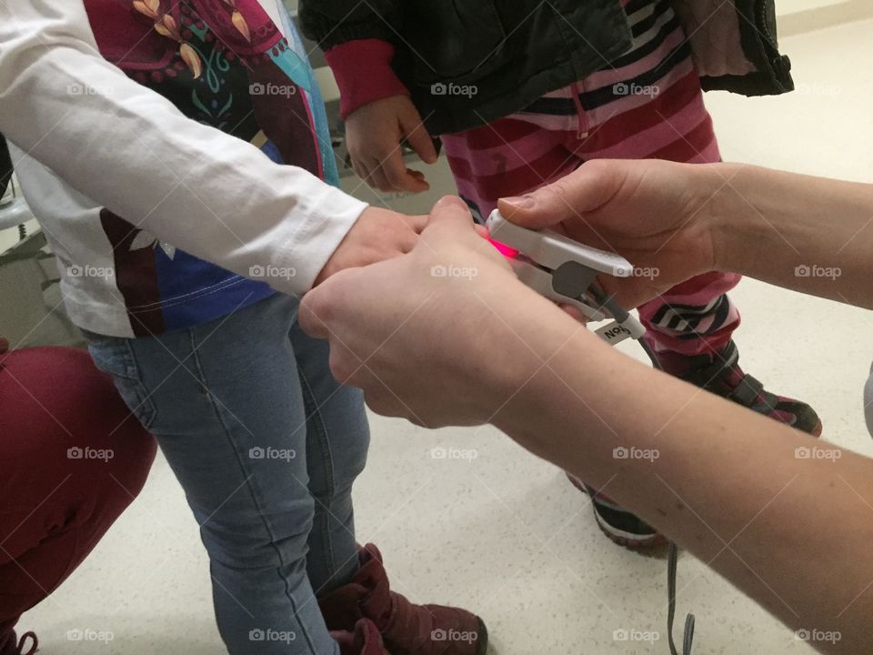 Doctor checking the puls with a Heart Rate Monitor on a child at the hospital.