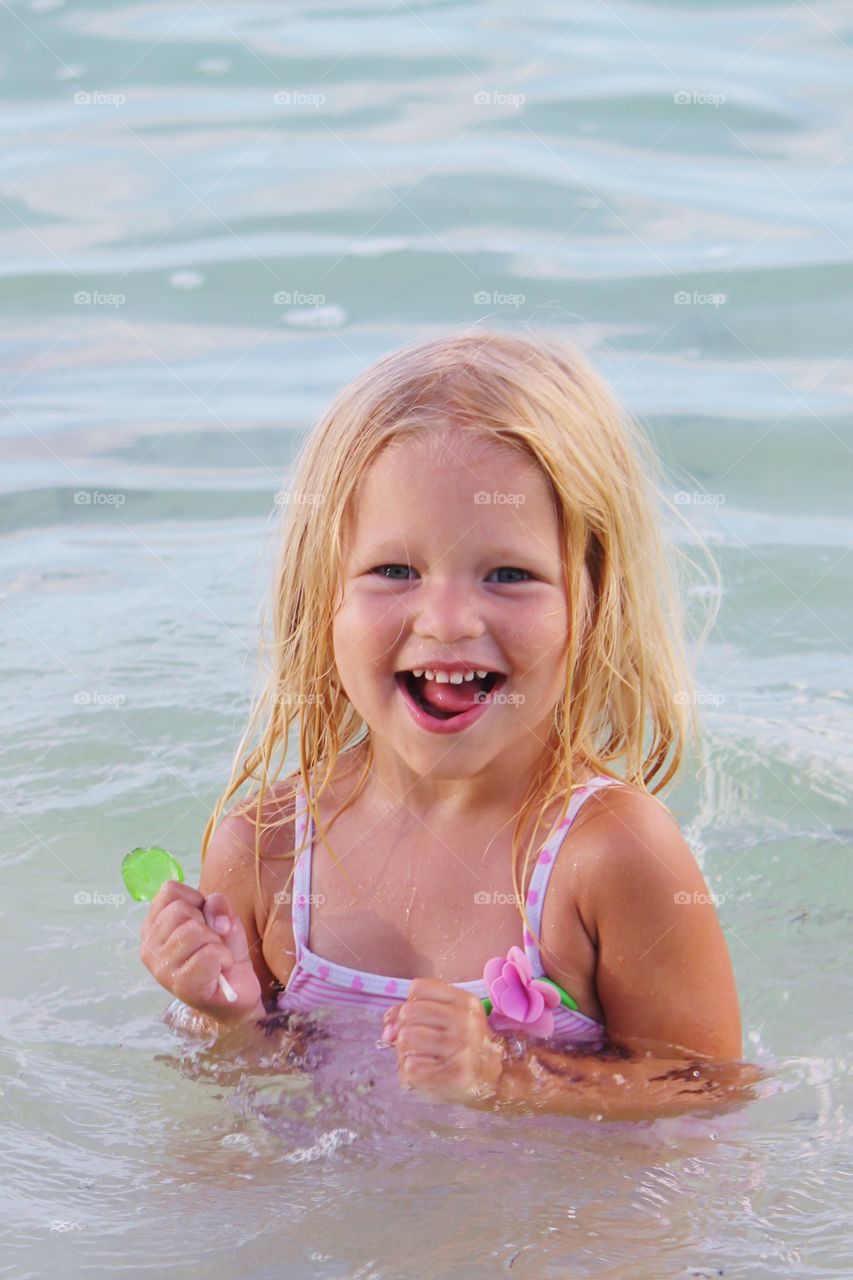 Portrait of a cute girl in water