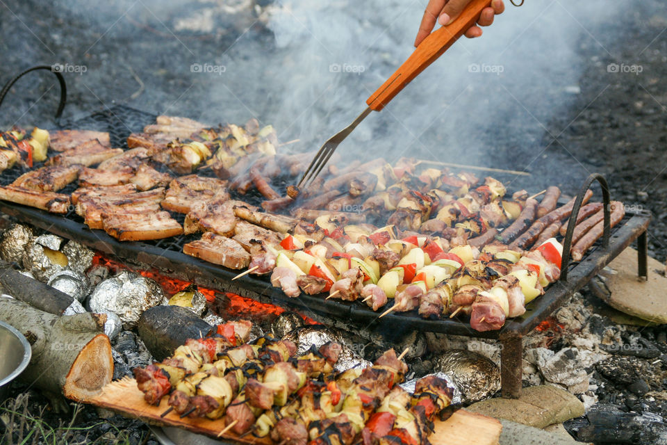 Hand's grilling on barbecue