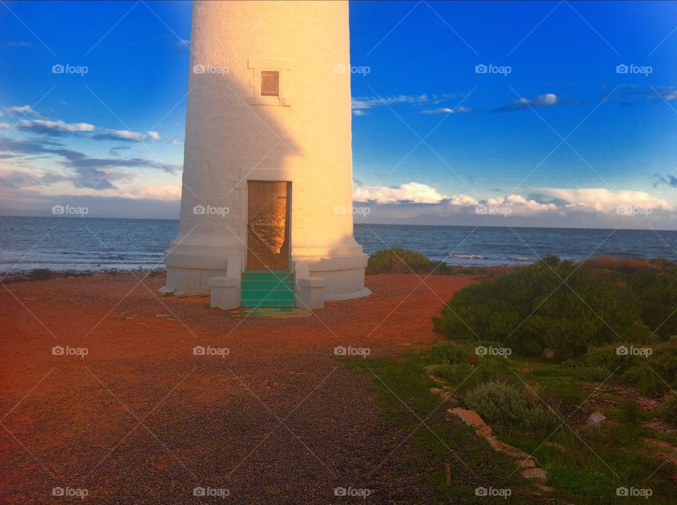 Lighthouse in low sun's glow. Lighthouse in low sun's glow