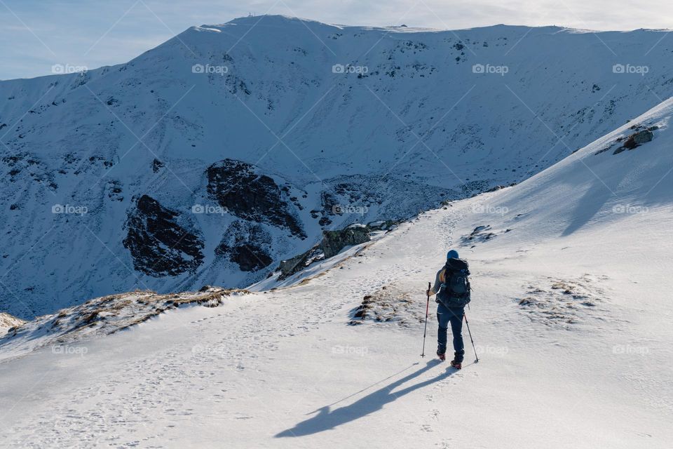 Man on hike on a winter day in the mountains.