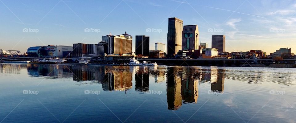 Reflections of my hometown, Louisville Kentucky. 

Sunny fall day on the Ohio River following a barge down river across the Louisville skyline!