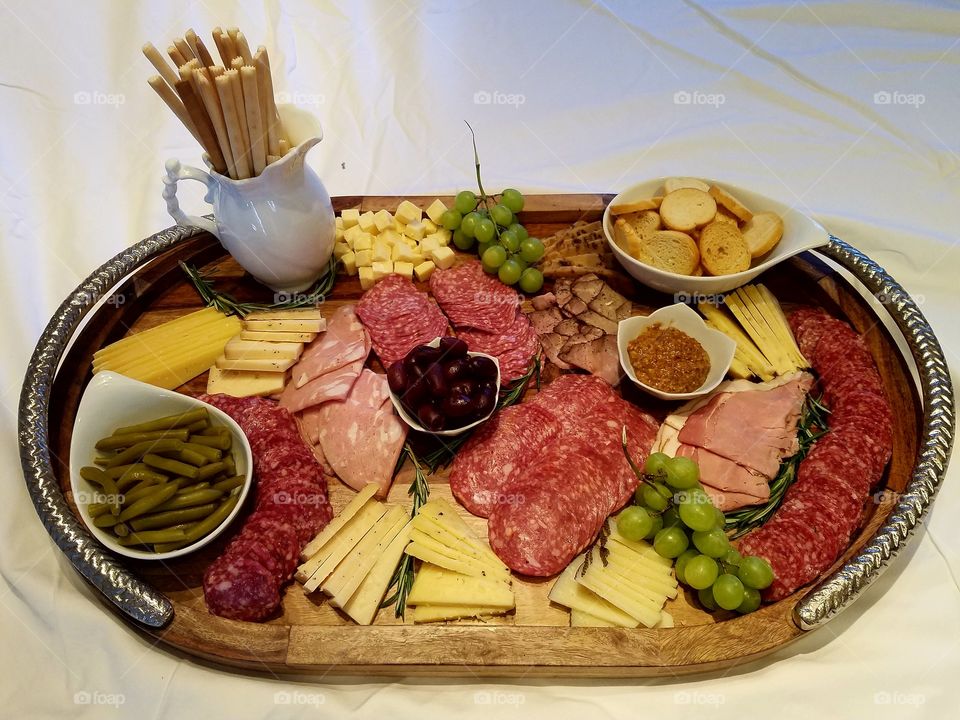 Charcuterie Board with Italian Meats, Cheeses, Breadsticks, Crostini, and Fruit