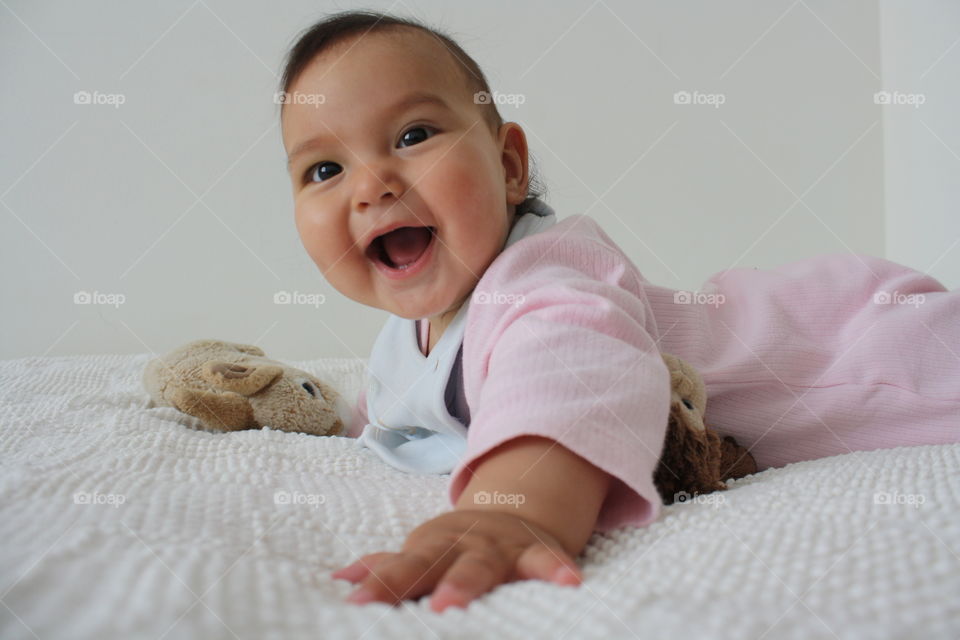 Happy girl lying on bed