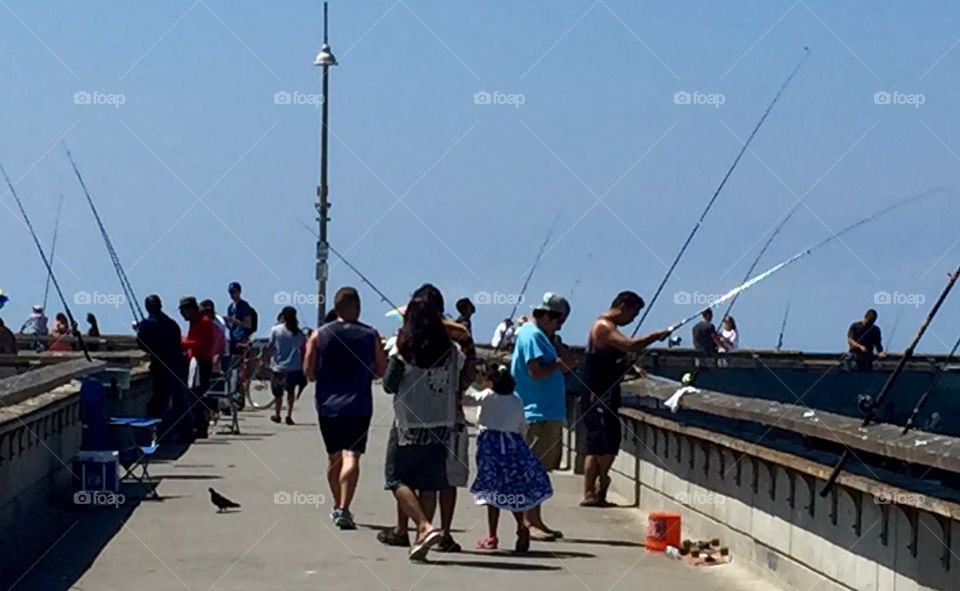 Fishermen and tourists fill the pier