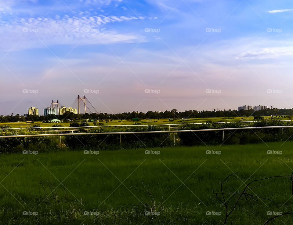 The landscape at kolkata natural nature view skyline favorite famous Racecourse people gallery garden sports competition vidyasaagar setu bridge green grass blue sky beautiful view kolkata bengal india.