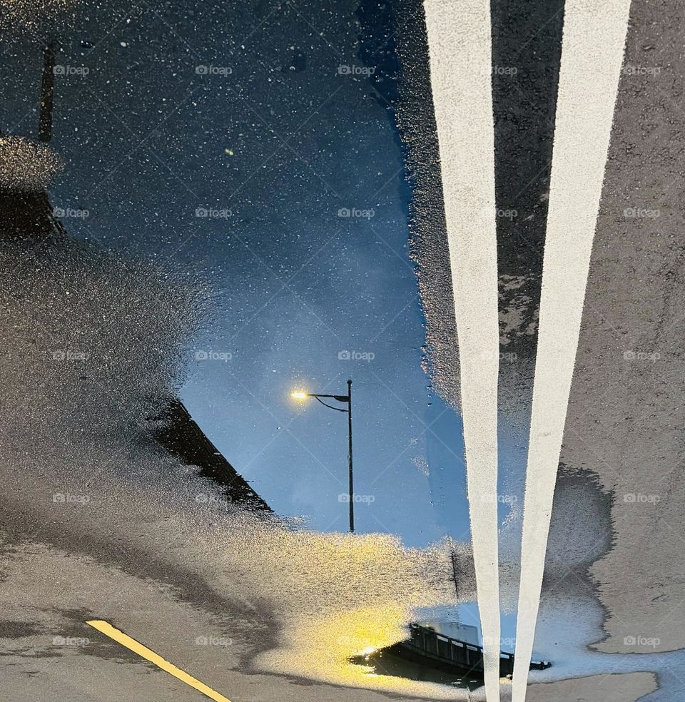 Streetlight reflected in puddle 