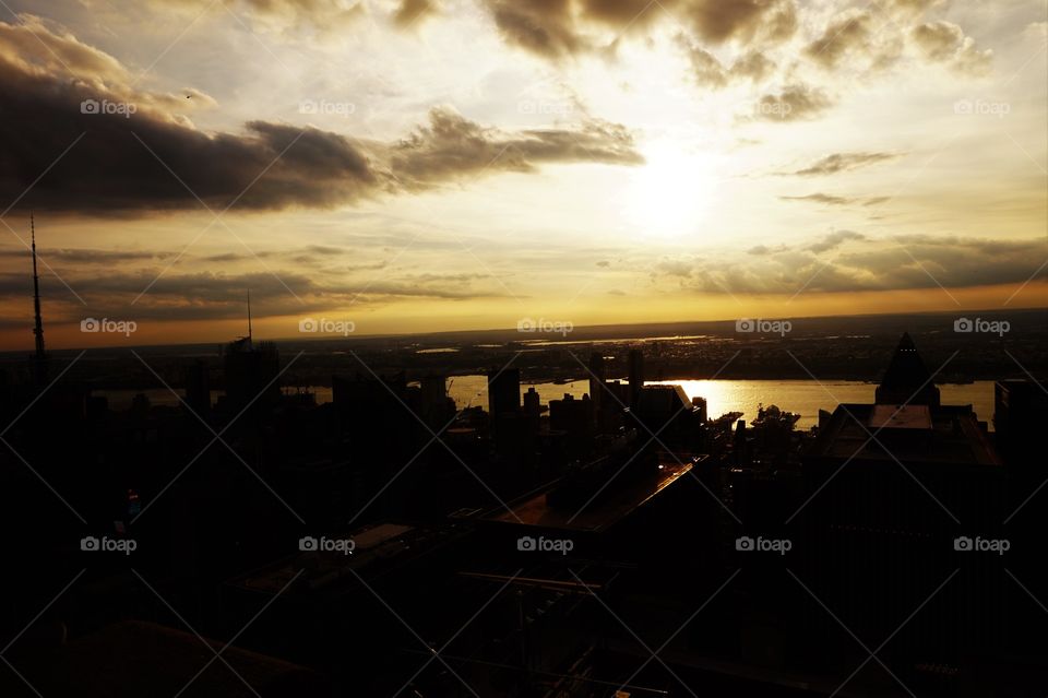 silhouette of buildings and a yellow/gold sunset