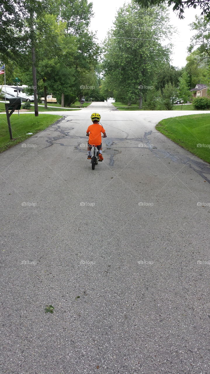 My First Ride. Boy riding bike for his first time