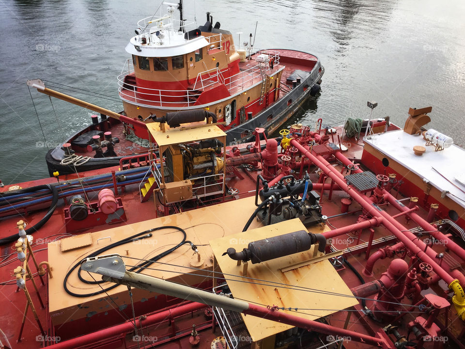 Tug boat guiding a fuel barge