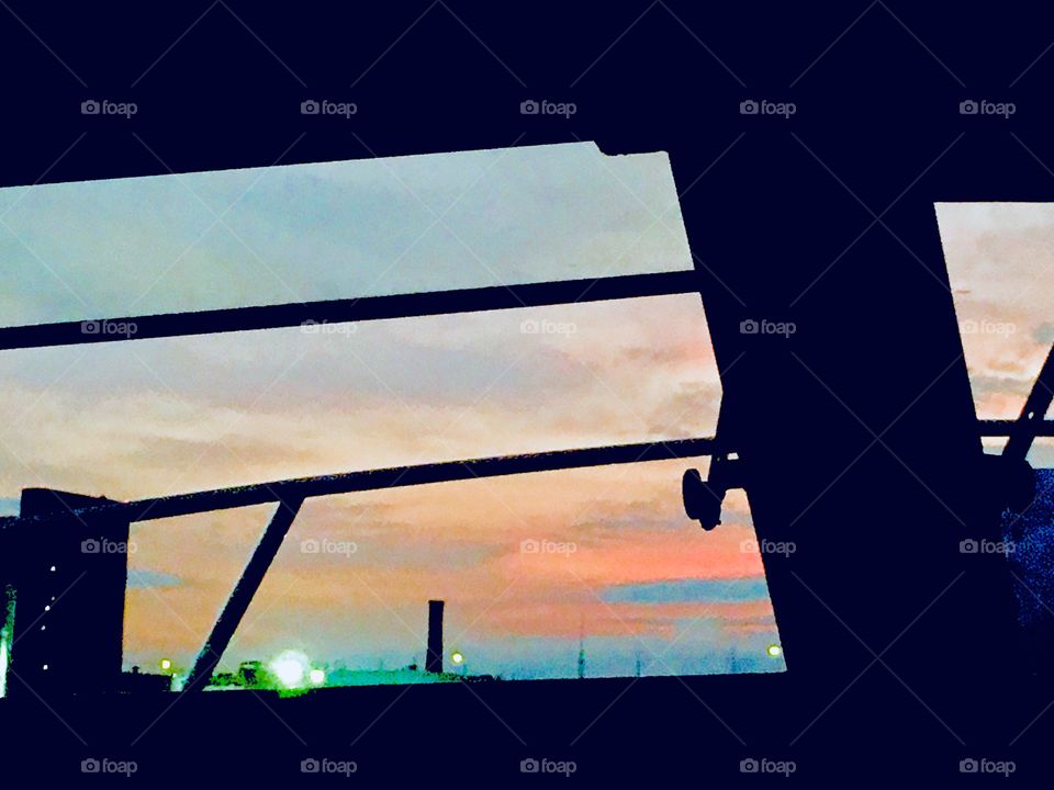 A view from our sailboat “Salvation” onto the evening sky and just a hint of the cityscape on the horizon on the other side of the waters of the East River at Newtown Creek in Long Island City, Queens, NY. Photo from 2018. Hypnotic Productions