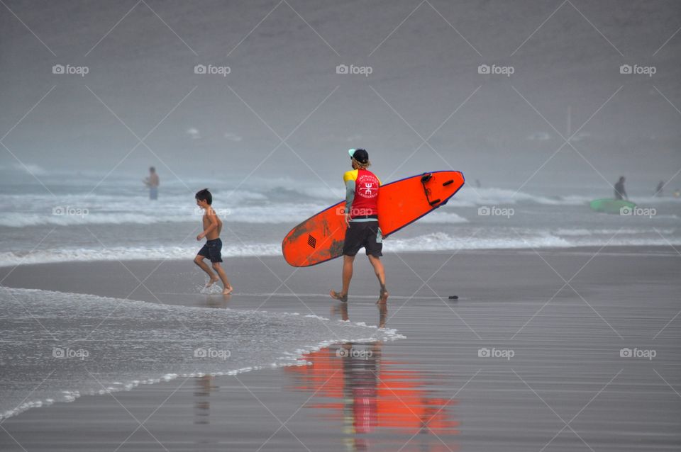 surfing on famara beach on lanzarote canary island in Spain