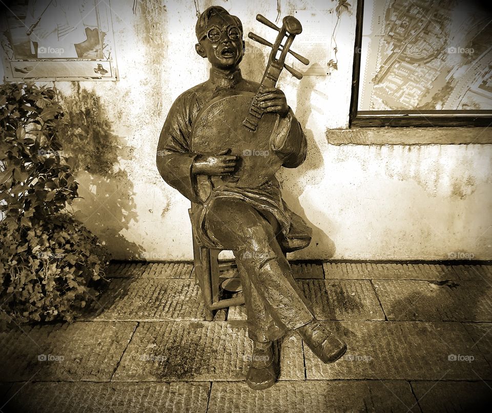 An old statue in a backstreet of Changsha, China.