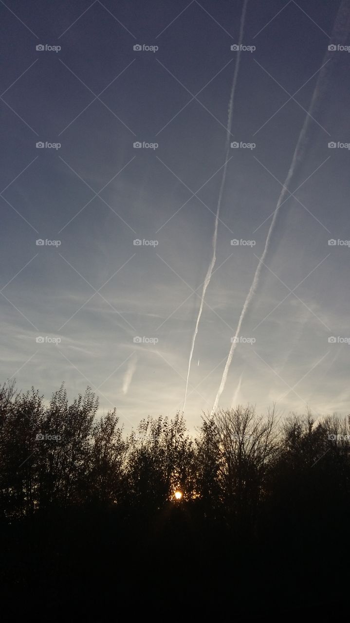 Plane trails on the sky in sunset