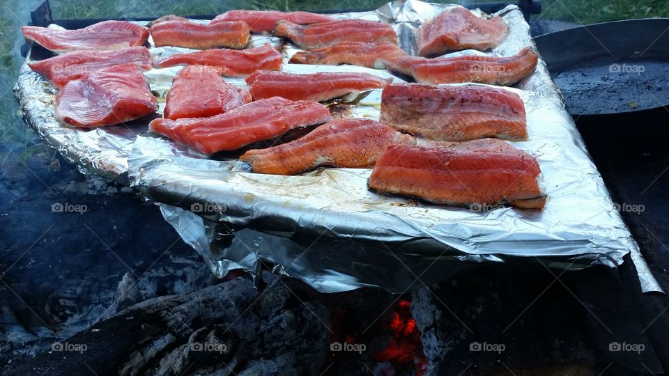 Fresh caught salmon being cooked and smoked. A favorite treat.