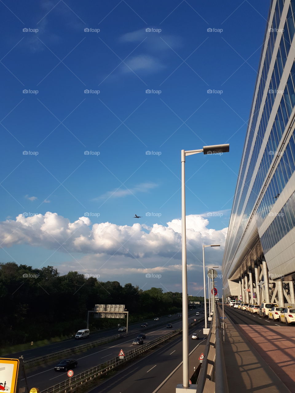 Frankfurt airport. Airplane flies over the road