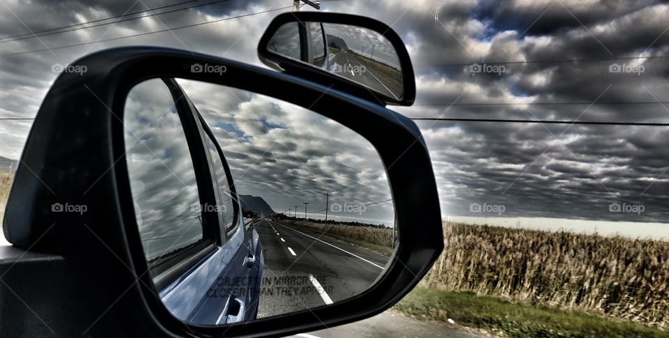 road in the mirror of car
