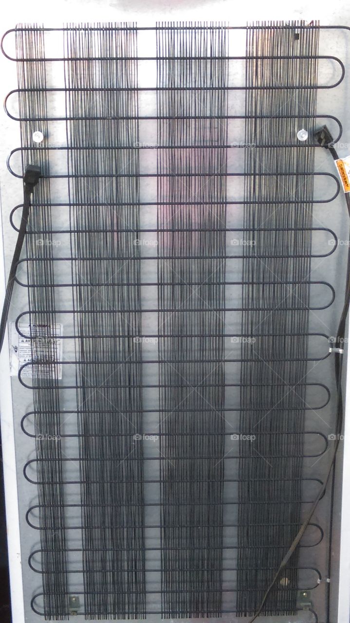 Back of a refrigerator - condenser array.