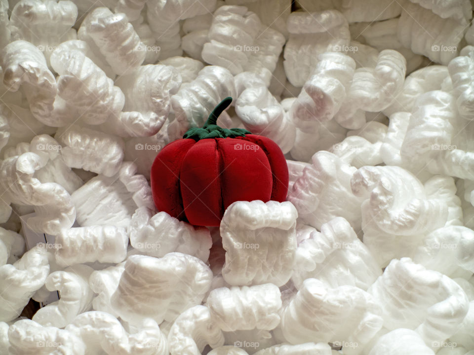 Little pumpkin in a cardboard box with styrofoam.