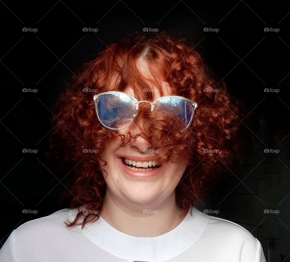 Happy photo of a girl with red curly hair