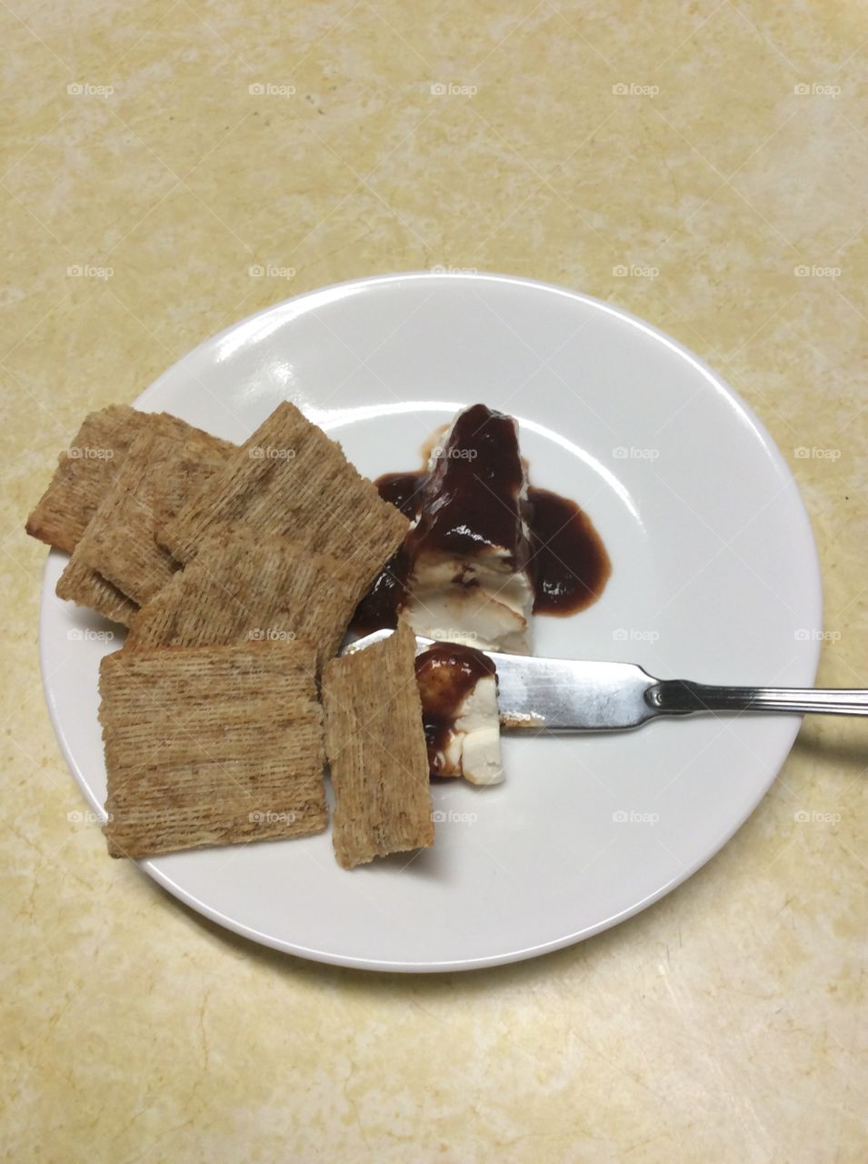 Triscuits with cream cheese for a snack