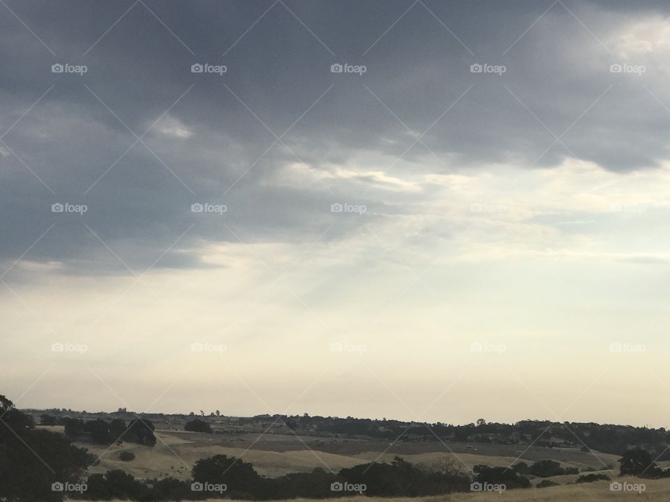 Ray of sun shining through the grey skies and clouds 