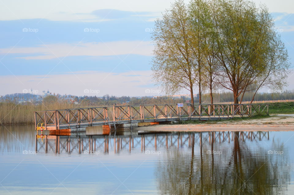 lake with pier and reflection