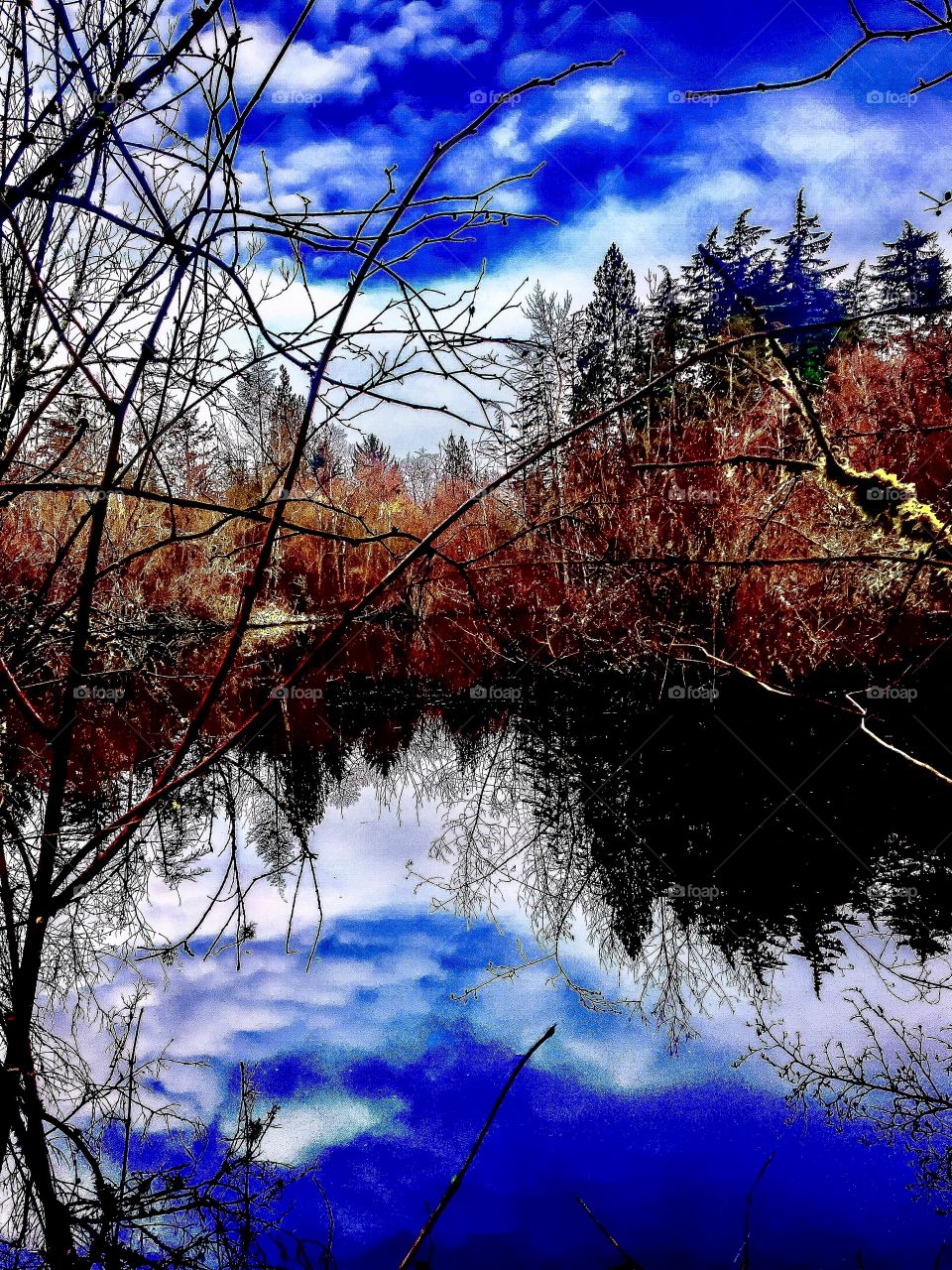 Clouds reflected on water during autumn